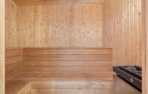 a sauna with wooden walls and a wooden floor at Awesome Home In Bording With Sauna in Korning +17 photos