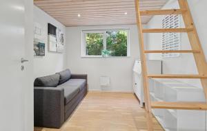 a living room with a couch and a ladder at Awesome Home In Bording With Sauna in Korning