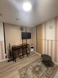 a living room with a desk and a television at Haverims Cozy and Neat Basement in Edmonton