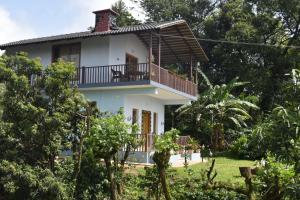 a view of the house from the garden at Naisarga hill view homestay in Somvārpet