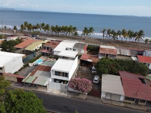 an aerial view of a town with a beach at Japandi Las Islas in Puntarenas