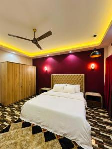 a bedroom with a large white bed with purple walls at Feather Villa in Talpe +38 photos