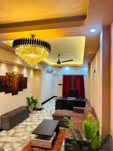 a living room with a couch and a chandelier at Feather Villa in Talpe
