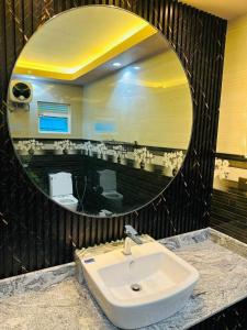 a bathroom with a sink and a large mirror at Feather Villa in Talpe