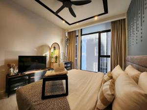 a bedroom with a large bed and a television at WGS Suites at KLCC, 300Mbps WiFi in Kuala Lumpur