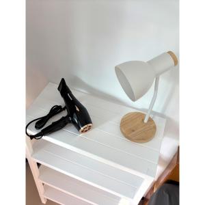 a desk with a lamp and a phone on it at Blue House Klong Hin in Ko Kood