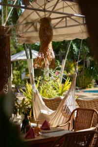 a couple of chairs in a hammock under an umbrella at Deep Forest Garden Hotel in Puerto Princesa City