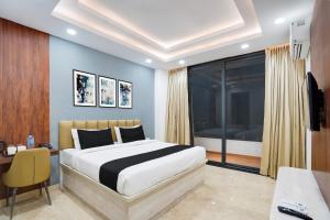 a bedroom with a bed and a desk and a window at Townhouse Sector 51 Gurgaon in Gurgaon