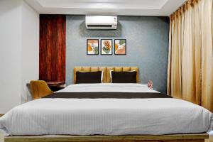 a bedroom with a large white bed and a blue wall at Townhouse Sector 51 Gurgaon in Gurgaon +30 photos