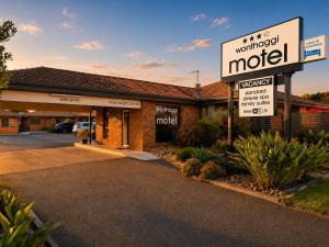 a motel with a sign in a parking lot at Wonthaggi Motel in Wonthaggi