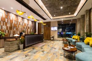 a lobby with a blue couch and a table at Soaltee Westend Lakeside Pokhara in Pokhara