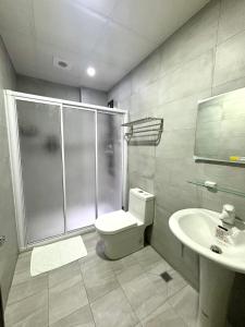 a bathroom with a shower and a toilet and a sink at 雀居民宿 in Yuli +66 photos