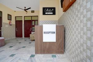 a reception room with a sign on a wall at Hotel O Chandigarh Outer Ring Road Formerly Ganesha in Chandīgarh
