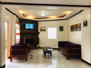 a living room with two pianos and a fireplace at The Verandah Lodge Bed and breakfast in Banaue