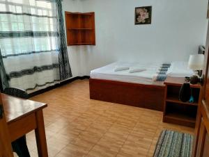 a small bedroom with a bed and a window at The Verandah Lodge Bed and breakfast in Banaue +1 photo