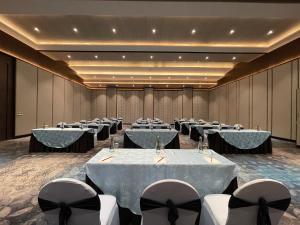 a conference room with rows of tables and chairs at Soaltee Westend Lakeside Pokhara in Pokhara +45 photos