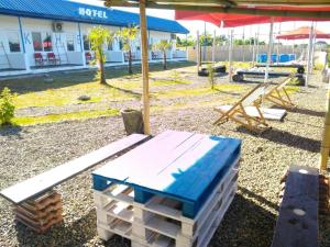 a picnic table and a bench in front of a building at jibo in Grigoleti