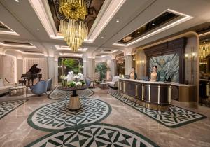 a hotel lobby with a bar and a piano at Classyc Hotel Hang Buom in Hanoi +75 photos