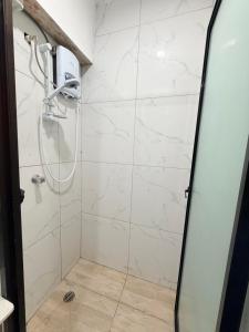 a shower with a glass door in a bathroom at Malima Stay in Suva