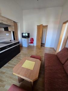 a living room with a couch and a table at Hotel Corso T-X in Rokycany