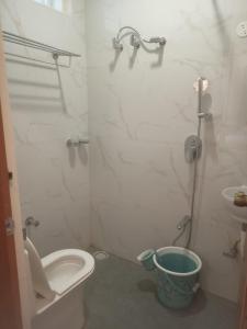 a bathroom with a shower and a toilet and a sink at The Royal Pavilion Hotel in Kanipakam