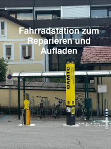 a gas station with a yellow sign in front of a building at Kristall, Doppelzimmer mit Balkon in Toplage, Zentrum in Bad Ischl