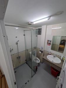 a bathroom with a shower and a toilet and a sink at Usagiyah Hotel & Guest House in Ho Chi Minh City +50 photos