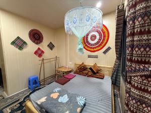 a bedroom with a bed with decorations on the wall at Homestay Hoàng Vũ in Ha Giang