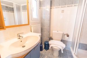 a bathroom with a sink and a toilet at Villa Nefeli Akti Salonikiou B in Ayios Nikolaos Sithonia +34 photos