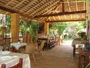 an outdoor restaurant with tables and chairs and a wooden ceiling at Hotel Restaurant Paraiso TINY in Villarrica
