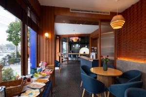 a restaurant with blue chairs and tables in a room at Salee Boutique Hotel in Chiang Mai