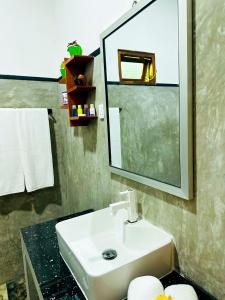 a bathroom with a sink and a mirror at Sigiri Grand Villa in Sigiriya +32 photos