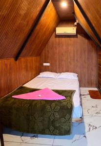 a small room with a bed in a attic at Tribez Valley Resort in Anaviratty