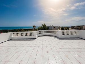 a white fence on a roof with the ocean in the background at Villa TAHA piscine jacuzzi clim in Martil +17 photos