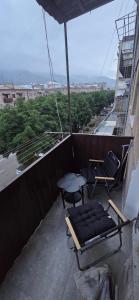a balcony with a bed and chairs and a table at Avenue B&B in Vanadzor +3 photos