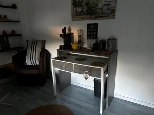 a kitchen with a stove in the corner of a room at Sevchris in Saint-Laurent-de-la-Prée