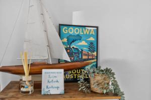 a wooden sail boat on a shelf with a sign at River & Tide escape - On Galpin in Goolwa South