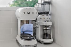 a mixer sitting on top of a counter next to a coffee maker at River & Tide escape - On Galpin in Goolwa South