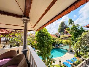 a view of a swimming pool from the balcony of a house at Kusnadi Hotel in Legian