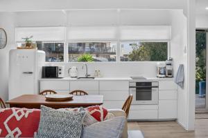 a kitchen and living room with a table and a couch at River & Tide escape - On Galpin in Goolwa South +32 photos