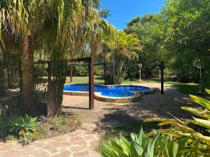 a pool with a gazebo in a garden at Hotel Restaurant Paraiso TINY in Villarrica +24 photos