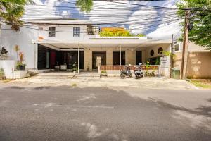 a house with a motorcycle parked in front of it at Amaya Residence Jimbaran in Jimbaran