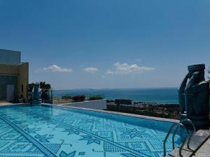 a swimming pool on the roof of a building at Sea La Vie Tuy Hoa Beachside Studio in Tuy Hoa