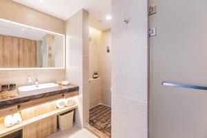 a bathroom with a sink and a shower at Atour Hotel (Yixing Huankeyuan) in Wuxi +12 photos