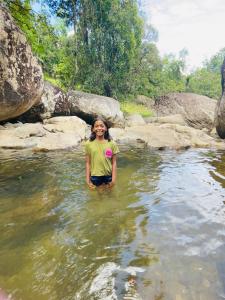 a woman standing in the water in a river at Clay house in Kurukohogama