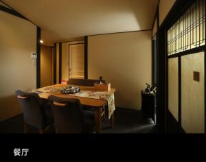 a dining room table with chairs and a box on it at Machiya Minami Omiya in Kyoto