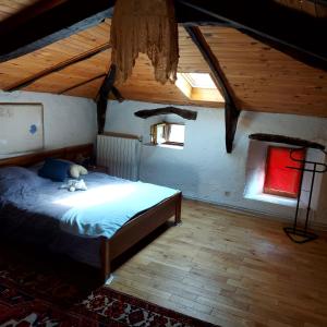 a bedroom with a bed with a teddy bear on it at Charensol in Saint-Sauveur-de-Montagut