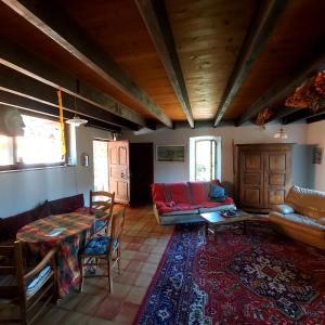 a living room with a couch and a table at Charensol in Saint-Sauveur-de-Montagut +8 photos