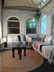 a room with beds and a coffee table in it at Parklane Motel in Launceston