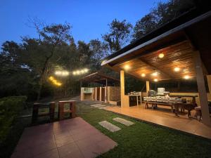 an outdoor patio with a table and a grill at Native House with beautiful pool in Bagac